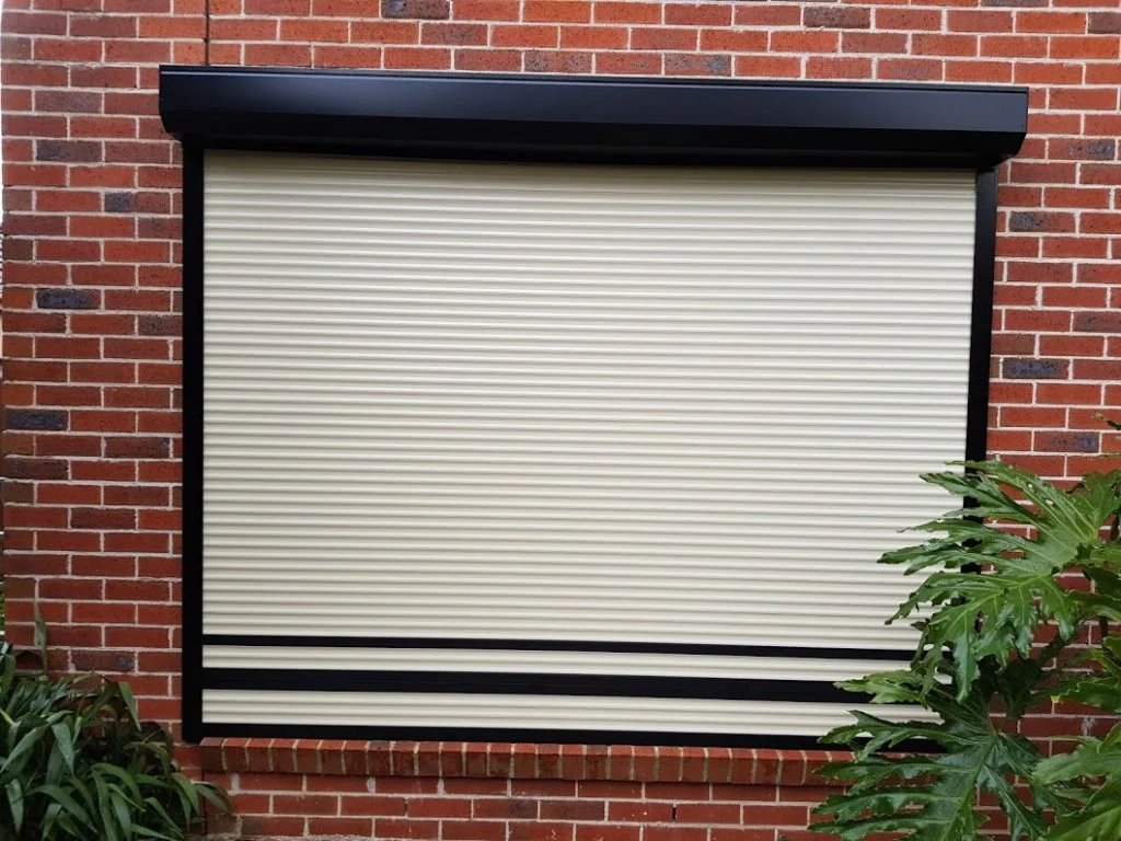 One charcoal roller shutter with maroon border at hte bottom